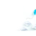 colored paper boat standing out from sea of others